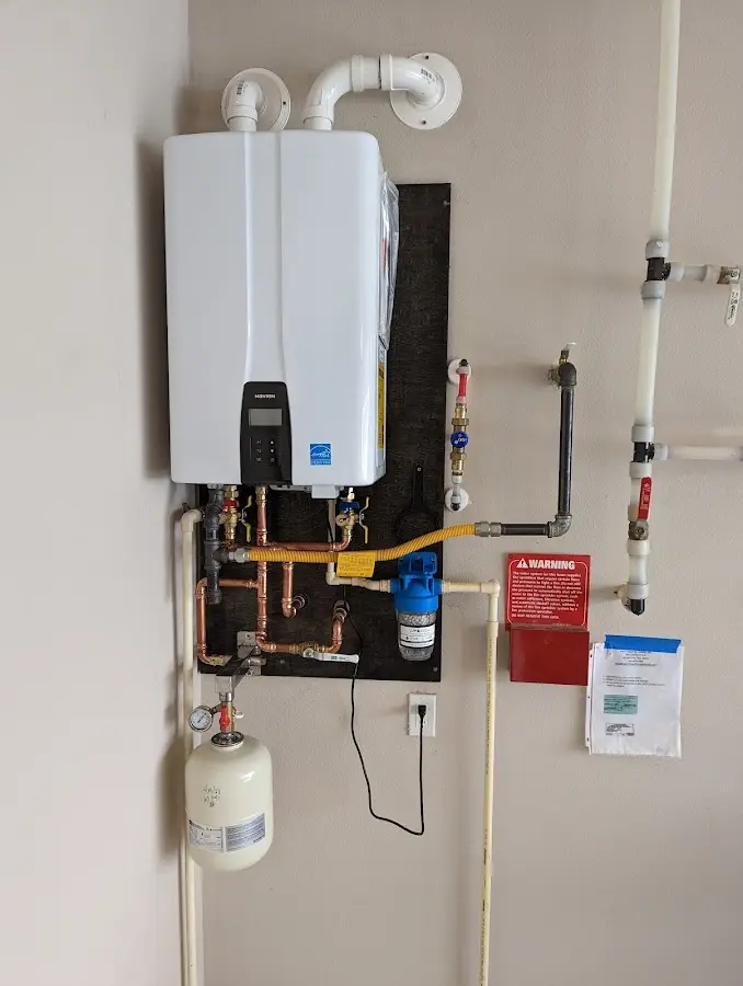 Professional plumber installing copper piping in a Plumas Lake home